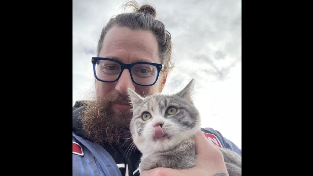 kitten jumps into man's arms to be rescued